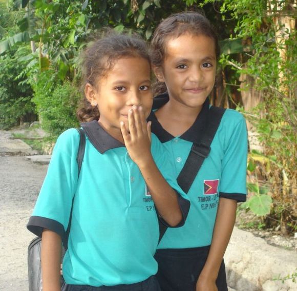 Two primary school girls in their uniforms Letting go of Indonesian